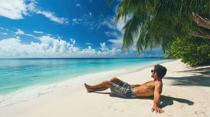 Obraz premium Man relaxes on a tropical beach under sunny blue skies