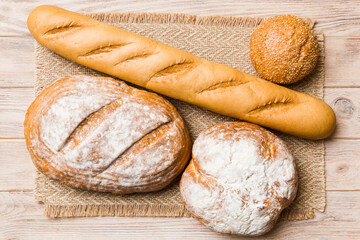 Assortment of freshly baked bread with napkin on rustic table top view. Healthy unleavened bread....
