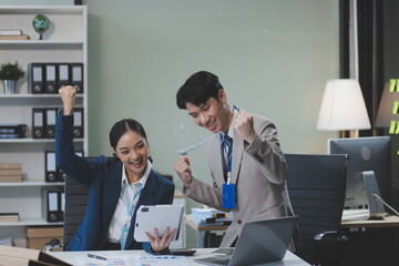 Group of Asia young creative people in smart casual wear discussing business celebrate giving five after dealing feeling happy and signing contract or agreement in office. Coworker teamwork concept.