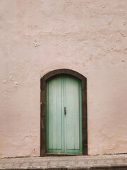 Green Door on Pink Wall