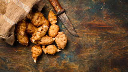 Linen bag with Jerusalem Artichokes or sunroot. Organic healthy food.