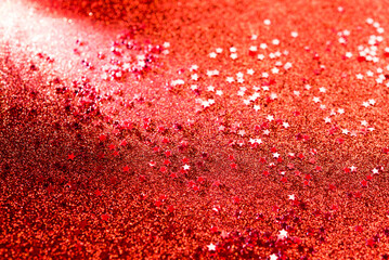 Red stars confetti on vibrant red background for celebrations and festive events