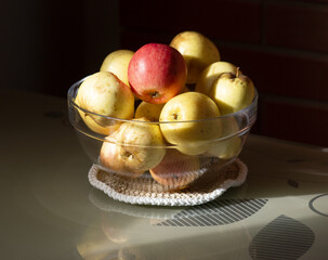 Glass Bowl of Fresh Yellow and Red Apples on Sunlit Table. Rustic Still Life Photography