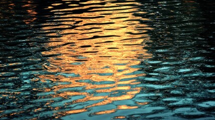 Rippled water reflecting sunset sky