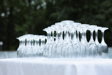 Empty, clean glasses are turned upside down. Glasses are on table. Buffet. Concept of party.