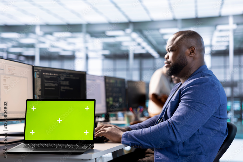 Poster server room programmer using green screen laptop to find firewall misconfigurations. african america
