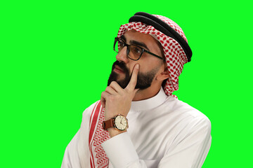 Thoughtful Arab Man in Traditional Attire Posing Against Green Screen Chroma no background