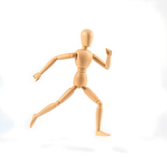 Wooden mannequin running isolated on white background