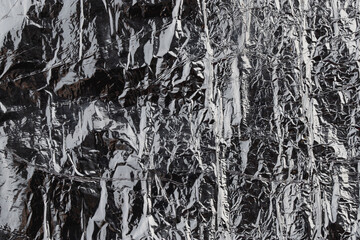 textured metal surface in dark gray color, background	