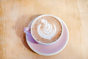 cup of hot cocoa or hot latte coffee with a leaf pattern.