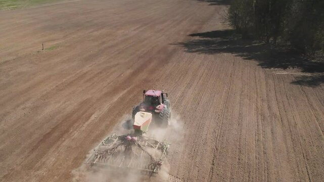 Tractor plants grain corn, aerial view