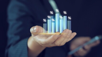 Businessman holding virtual bar graph chart and percentage for analysis stock market, technology investment and value investment concept.