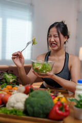 Young woman disgusted by eating healthy salad for weight loss diet