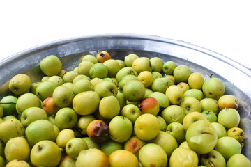 Indian jujubes in basket on table.Chinese date.Fresh jujubes. Fresh and delicious Indian jujube fruit with cut pulp. jujube fruits on a tree on a background of green leaves .Ziziphus mauritiana, also 