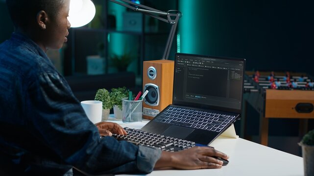 Freelancing admin in home office using laptop to write programming language code. Software technician working from home using notebook device to build application, camera A