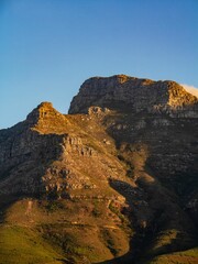 Mountain landscape at sunset with clear blue sky.