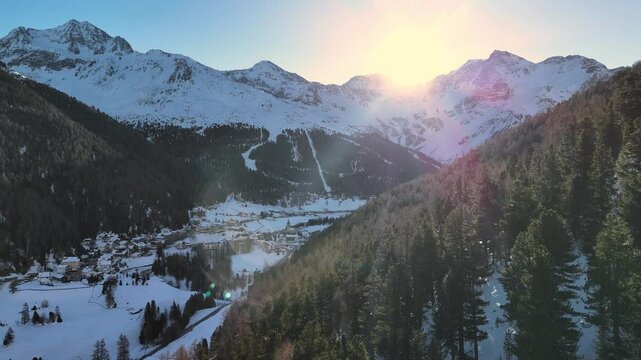 Aerial drone footage of flight over the Sulden valley in the European Alps at sunrise