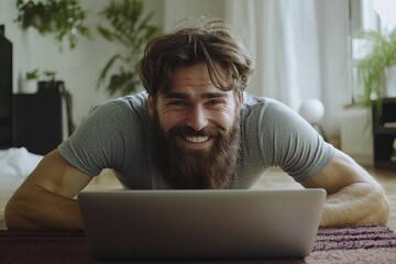 Hamstring Stretch. Smiling man practicing hamstring stretch exercise with laptop in modern living room
