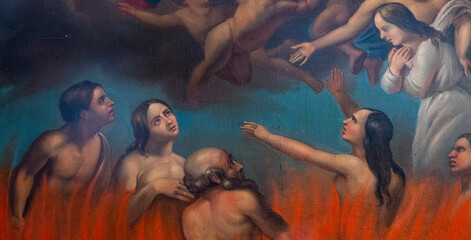 Puget Theniers, FRANCE, 02-17-2025: Painting (19th century) of Souls in purgatory fire waiting for...