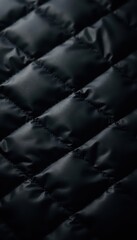 Fototapeta premium Black quilted fabric, subtle light reflection, backdrop, light