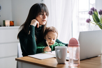 Mother balancing remote work and parenting with toddler. Digital age, career balance, modern family dynamics, multitasking, technology in parenting