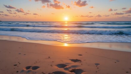Ocean Waves Washing Onto Sandy Beach at Sunrise with Footprints