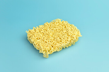 Dried Instant Noodles on blue table. top view