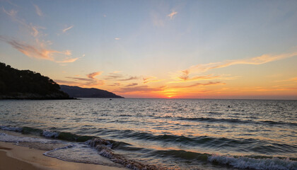 Obraz premium Sunset over beach with gentle waves and distant hills