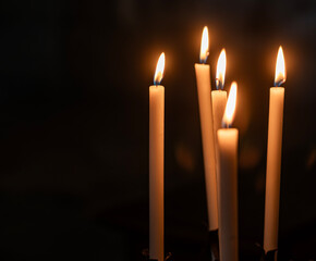 Flame candles isolated on black background. Close up burning memorial candles on the dark background
