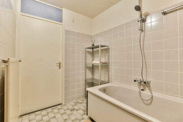 A clean and modern bathroom featuring minimalist design elements, with a showerhead, bathtub, and a shelf for storage.