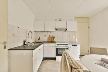 A sleek and contemporary kitchen featuring minimalist cabinetry, modern appliances, and a neutral...