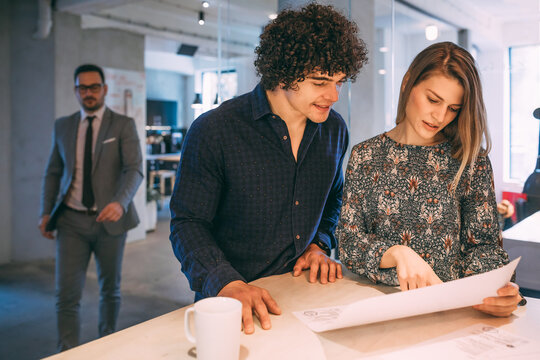 Couple looking at a project of new house.