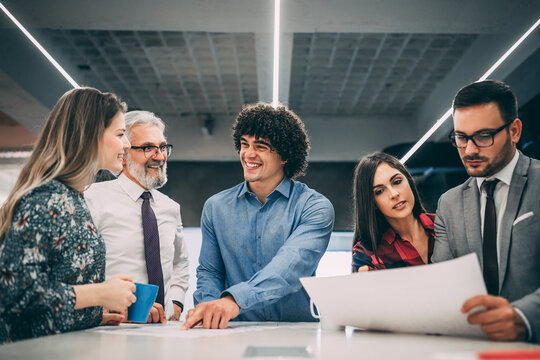 Happy business man with his colleagues having discussion about new project.