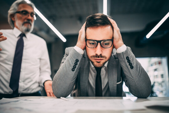 Handsome depressed man at office, Closeup