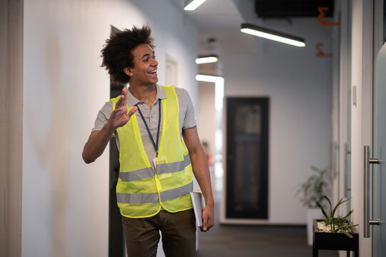 Dark-skinned serviceman checking the office doors locker after working day