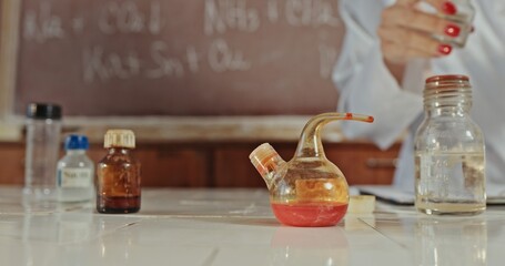 A vibrant and colorful laboratory scene showcasing a variety of glassware and numerous chemicals