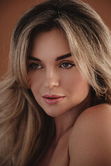 Fototapeta premium Beautiful Woman with Long Blonde Hair Posing in Studio Close-Up
