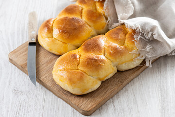 Traditional Easter braided bread. Tsoureki braid on white wooden table