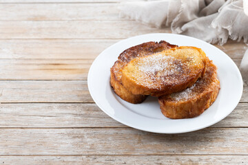 Traditional Spanish torrijas for Holy Week on wooden table. French Toast. Copy space