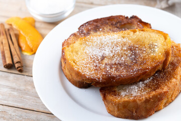 Traditional Spanish torrijas for Holy Week on wooden table. French Toast.