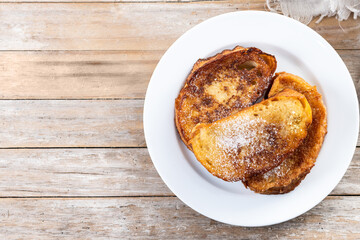 Traditional Spanish torrijas for Holy Week on wooden table.  French Toast. Top view. Copy space