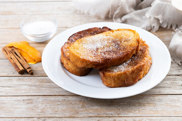 Traditional Spanish torrijas for Holy Week on wooden table. French Toast.