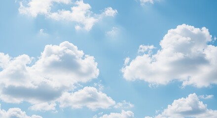 Obraz premium Bright blue sky filled with fluffy white clouds, peaceful atmosphere