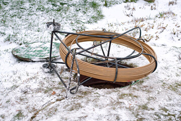 Fiber optic cable spool for underground internet installation in winter conditions with snow...