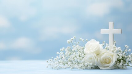 White roses with cross against soft blue background