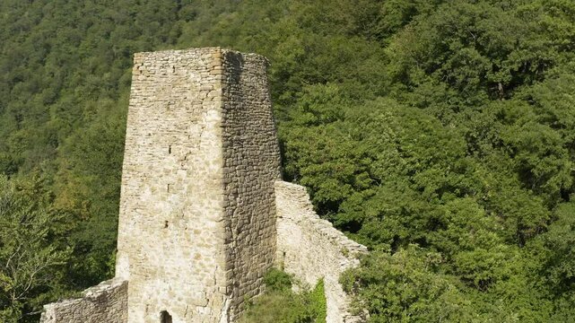Stunning aerial view of historic Mere fortress and Sionis Koshki, hidden in lush caucasus Mountains. medieval stone fortress stands as architectural and cultural heritage.