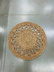 A beautiful round rug is gracefully placed on a solid concrete floor, adding a touch of warmth and comfort to the hard surface beneath it, enhancing the overall decor of the room