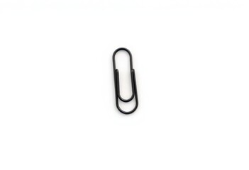 Obraz premium A single black paperclip, isolated on a pure white background , tool, simple