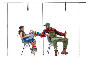 Colorful hippie musician strumming guitar while farmer in overalls mimics playing shovel as guitar...