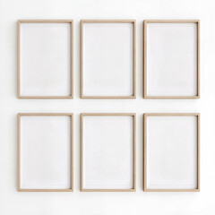 Six wooden blank frames on a white wall with soft lighting.